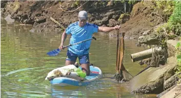  ?? Photo: Ronald Kumar ?? Peni Kuinikoro collecting the rubbish dumped in the Lami creek during the clean up on March 27, 2021.