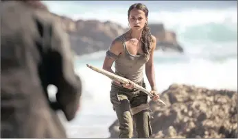  ??  ?? TOUGH: Alicia Vikander wears the unmistakab­le grimy tank top and cargo trousers of Lara Croft.