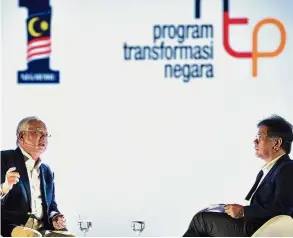  ?? — Bernama ?? Fact of the matter: Najib stressing a point during a dialogue session moderated by Idris at the NTP event.