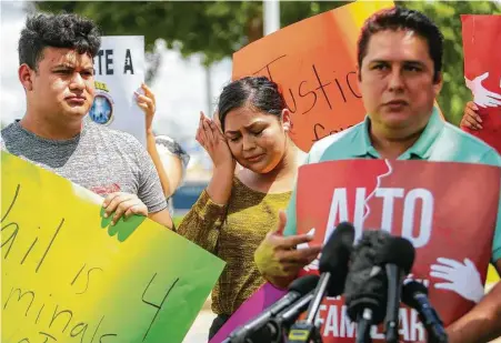  ?? Mark Mulligan / Houston Chronicle ?? Alejandro Garcia talks about his wife, Lucia Montes, who was detained by Deer Park police during a Monday traffic stop, while his daughter, Alejandra, cries during a news conference outside the Deer Park Police Department on Wednesday.