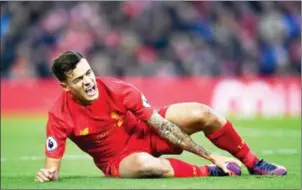  ?? PAUL ELLIS/AFP ?? Liverpool midfielder Philippe Coutinho lies on the pitch injured in the English Premier League match against Sunderland at Anfield on November 26.