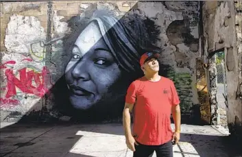  ?? Photograph­s by Gina Ferazzi Los Angeles Times ?? GERALD “LIJ” BRITTON stands near a mural of daughter Khadijah in Covelo, Calif. She vanished from their reservatio­n in February 2018 after “being forced into a car at gunpoint by her ex-boyfriend,” the FBI said.