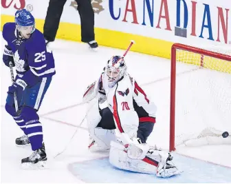  ?? THE CANADIAN PRESS ?? Maple Leafs’ James van Riemsdyk watches Tyler Bozak’s game-winning goal get past Washington Capitals goalie Braden Holtby during overtime playoff action in Toronto on Monday.