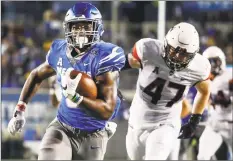  ?? Mark Weber / The Commercial Appeal via AP ?? Memphis running back Patrick Taylor Jr., left, runs past UConn defender Santana Sterling on his way to a touchdown on Saturday.