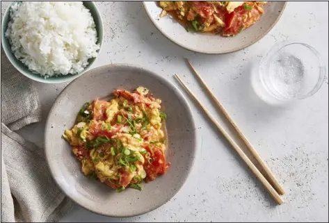  ?? SANG AN — THE NEW YORK TIMES ?? Chinese Stir-fried Tomatoes and Eggs. If you were the sort of kid who drowned their scrambled eggs in ketchup, this dish is for you.