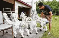  ??  ?? Kunal Panigrahi unpacks horses for the deity chariot from storage.