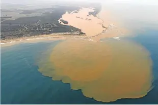  ?? Picture: REUTERS ?? ORANGE TIDE: An aerial view of the Doce River, which was flooded with mud after a dam owned by Vale and BHP Billiton burst, at an area where the river joins the sea on the coast of Espirito Santo in Regencia village, Brazil