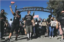  ??  ?? Black Lives Matter organizers march Sunday in Martinez in response to the vandalism of the mural and other incidents. The march drew hundreds of people, including groups that traveled the country. Find more on the protest at sfchronicl­e.com/martinezpr­otest.