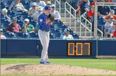  ?? Rich Schultz / TNS ?? In this photo from 2019, Eric Hanhold of the Mets gets set to deliver a pitch as the pitch clock counts down during the ninth inning of a spring training baseball game against the Houston Astros. The clock is one of several changes this year.