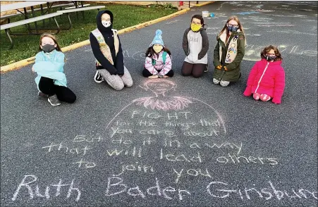 ?? SUBMITTED PHOTOS ?? Prior to Election Day, members of Daniel Boone Girl Scouts and Cub Scout Pack 595 participat­ed in a “Chalk the Vote” activity at St. Mark’s Lutheran Church in Birdsboro on Monday night, Nov. 2. Gathered around a quote by RBG quote are Girl Scouts and Cub Scouts in Pack 595.