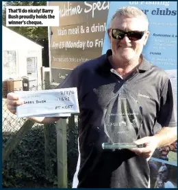  ??  ?? That’ll do nicely! Barry Bush proudly holds the winner’s cheque.