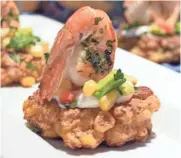  ?? TERRI MILLIGAN ?? Shrimp and corn cakes make an attractive presentati­on.