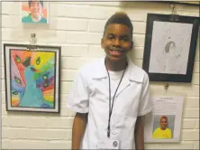  ??  ?? Artist James Robert Johnson stands next to two of his drawings in the “Artists Without Limits” exhibition.