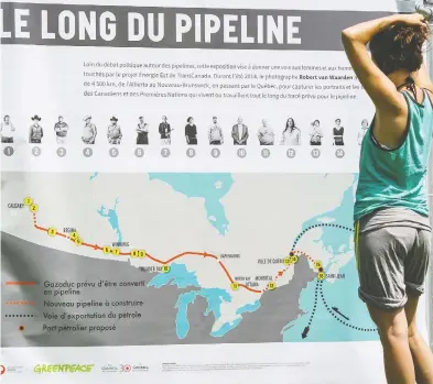  ?? FREDERIC HORE / POSTMEDIA NEWS FILES ?? Melissa Lachance of Montreal looks at a map of the proposed Energy East pipeline at a rally in 2015 organized by Greenpeace and other groups opposed to the project. The reality is that, whether the environmen­talists like it or not,
demand for oil will persist for decades to come and Canada's oil and gas will be needed, Diane Francis writes.