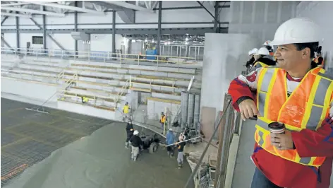  ?? DAVE JOHNSON/ WELLAND TRIBUNE ?? Tim Nohara, president of Accipiter Radar Technologi­es, watches as concrete is poured in the Accipiter Arena at the Pelham community centre at Highway 20 and Rice Road last month.