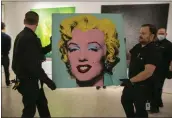  ?? TED SHAFFREY – THE ASSOCIATED PRESS ?? The 1964 painting “Shot Sage Blue Marilyn” by Andy Warhol is visible in Christie's showroom in New York City on Sunday.