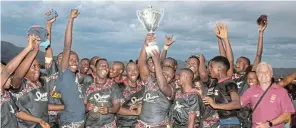  ?? Picture: UVIWE JARA ?? CELEBRATIO­N: Thambelihl­e High School’s rubgy team celebrate with the cup after winning the Heritage High School Tournament at John Noah High School.