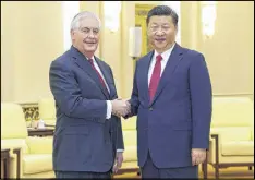  ?? LINTAO ZHANG / ASSOCIATED PRESS ?? U.S. Secretary of State Rex Tillerson (left) shakes hands with China’s President Xi Jinping at the Great Hall of the People in Beijing on Sunday.