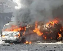  ?? AFP ?? Flames rise from the wreckage of vehicles following a reported air strike on a vegetable market in Maaret Al Numan in Syria’s northern province of Idlib on Sunday. —