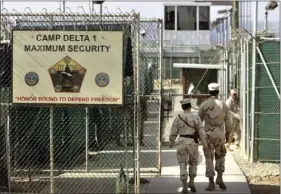  ??  ?? In this June 27, 2006 file photo, reviewed by a U.S. Department of Defense official, U.S. military guards walk within Camp Delta military-run prison, at the Guantanamo Bay U.S. Naval Base, Cuba. Attorney General Jeff Sessions is visiting Guantanamo Bay...