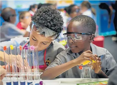  ?? Picture: MICHAEL SALZWEDAL ?? FUTURE SCIENTISTS: Lisa Mose, right, offers advice as Zozi Adam records their experiment at BASF Kids Lab on the opening day of Scifest 2018. The Kingswood College grade 4s are among thousands of pupils who attend Scifest every year