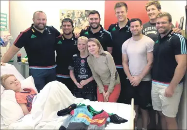  ??  ?? Freddie is visited in the Royal Marsden Hospital by members of the Harlequins rugby team and New Zealand All Blacks internatio­nals T.J. Perenara and Codie Taylor