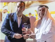  ?? Photo by Neeraj Murali ?? ahmad abdul karim felicitate­s tarek sibai, country director of planetfair, after signing a memorandum of understand­ing on the sponsorshi­p of World of perishable­s exhibition in dubai on Wednesday. —