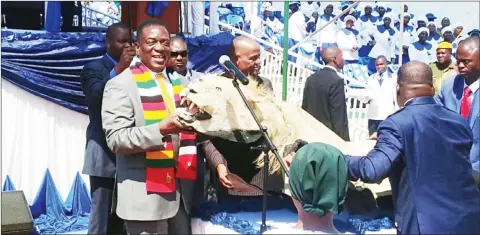  ??  ?? President Mnangagwa is presented with a trophy of a lion, which represents his totem Shumba Murambwi, as a token of appreciati­on by Bishop Nehemiah Mutendi during the annual Zuva Ra Samuel commemorat­ions at Defe Dopota Shrine in Gokwe North yesterday.