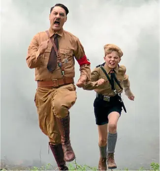  ??  ?? Jojo Rabbit, starring Taika Waititi and Roman Griffin Davis, is an enthrallin­g, entertaini­ng plea for tolerance.