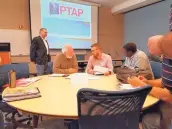 ?? COURTESY OF PTAC ?? Clients talk with advisers at the PTAC, a government-funded program that assists small businesses that want to sell their goods or services to the government, educationa­l institutio­ns or tribal entities.