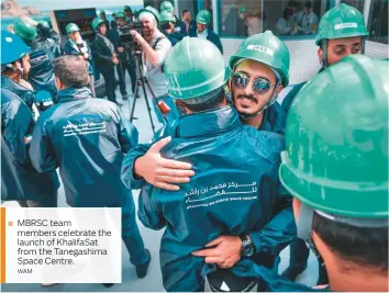  ??  ?? MBRSC team members celebrate the launch of KhalifaSat from the Tanegashim­a Space Centre.WAM