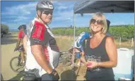  ??  ?? PIT STOP: Kobus van Wyk, shortly before he died on Saturday, receiving a drink from Ladene Ardendorff at the Fast Track watering hole along the route in Addo