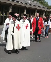  ??  ?? Sunday’s procession leaving Holy Family church.