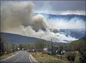  ?? JIM WEBER — SANTA FE NEW MEXICAN VIA AP ?? A flare up near Cleveland, just down 519from Mora, N.M. darkens the sky on Wednesday where firefighte­rs have been battling the Hermit's Peak and Calf Canyon fire for weeks.
