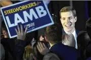  ?? DREW ANGERER/GETTY IMAGES ?? Democrat Conor Lamb greets supporters at an election night rally in Canonsburg, Pa. Lamb, who has declared victory, leads by 627 votes.