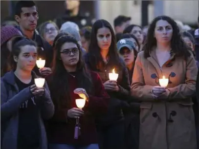  ?? Nikos Frazier ?? The Associated Press Students and community members listen to speakers Monday during a candleligh­t vigil at Michigan State University Hillel in East Lansing, Mich., in response to Saturday’s shooting at a Pittsburgh synagogue.
