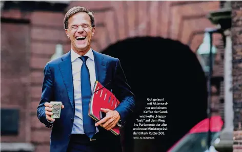  ?? FOTO: ACTION PRESS ?? Gut gelaunt mit Aktenordne­r und einem Kaffee der Sandwichke­tte „Happy Tosti“auf dem Weg ins Parlament: der alte und neue Ministerpr­äsident Mark Rutte (50).