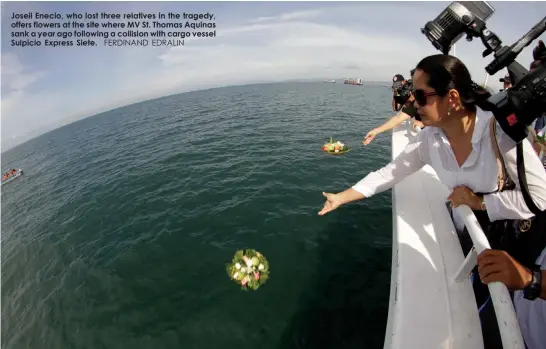  ?? FERDINAND EDRALIN ?? Joseil Enecio, who lost three relatives in the tragedy, offers flowers at the site where MV St. Thomas Aquinas sank a year ago following a collision with cargo vessel Sulpicio Express Siete.