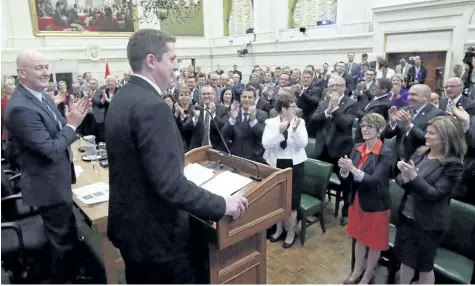  ?? FRED CHARTRAND/THE CANADIAN PRESS ?? Newly-elected Conservati­ve Party Leader Andrew Scheer receives a standing ovation from his Conservati­ve caucus on Parliament Hill in Ottawa in May. A mix of Conservati­ve veterans and relative rookies will form the team behind Scheer as he faces off...