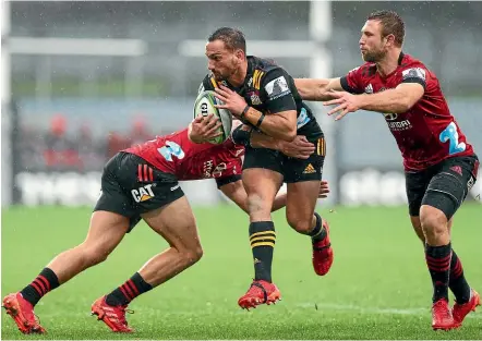 ?? GETTY IMAGES ?? Chiefs first five-eighth Aaron Cruden, here taking on the Crusaders defence, says his side has to improve its kicking game ahead of the Super Rugby Aotearoa match against the Hurricanes in Hamilton on Sunday.