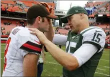  ?? RON SCHWANE — THE ASSOCIATED PRESS ?? New York Jets quarterbac­k Josh McCown (15) talks with Cleveland Browns quarterbac­k Kevin Hogan (8) after an NFL football game, Sunday in Cleveland.