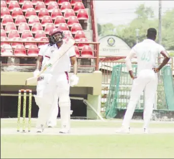  ??  ?? Amir Jangoo acknowledg­es the applause of his teammates upon reaching his half century with a boundary (Romario Samaroo photo)