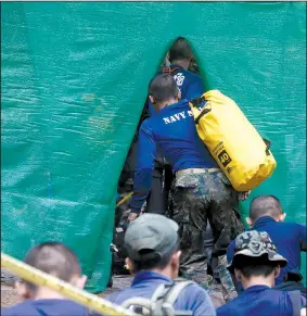  ?? AP/SAKCHAI LALIT ?? Rescuers arrive Sunday in Mae Sai, Thailand, near a cave where 12 boys and their soccer coach have been trapped since June 23.