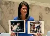  ?? PHOTO: REUTERS ?? US Ambassador to the United Nations Nikki Haley holds photograph­s of gas attack victims during a meeting at the United Nations Security Council on Syria.