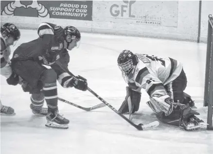  ?? KEVIN ADSHADE/THE NEWS TIMBERWOLV­ES 5 CRUSHERS 4 ?? Crushers goaltender Andrew MacLeod stones an Amherst Ramblers attacker in a Maritime Junior Hockey League game on Dec. 2. The Crushers won the game 6-3.