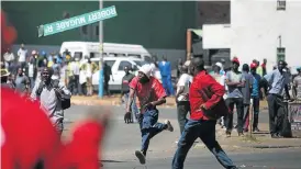  ?? Picture: AFP PHOTO ?? CHALLENGE FLUNG: Protests calling for economic reform have escalated in Zimbabwe as the government of President Robert Mugabe struggles to pay its many workers