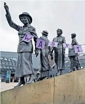  ?? ?? A Waspi banner on the statue of activist Mary Barbour, the woman who led rent strikes during the First World War, in Glasgow