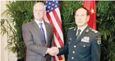  ?? — AFP ?? US Defence Secretary Jim Mattis shakes hands with his Chinese counterpar­t General Wei Fenghe during a meeting on the sidelines of the Associatio­n of Southeast Asian Nations (Asean) security summit in Singapore on Thursday.