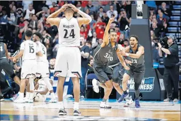  ?? Andy Lyons Getty Images ?? NEVADA’S JOSH HALL, NO. 33, celebrates with Hallice Cooke after the Wolf Pack erased a 22-point deficit in the final 11 minutes to defeat the Cincinnati Bearcats during the second round of the NCAA tournament.