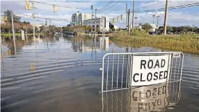  ?? MIC SMITH/ AP ?? Floodwater­s engulf the intersecti­on of Fishburne Street and Hagood Avenue this month in historic Charleston, S. C.